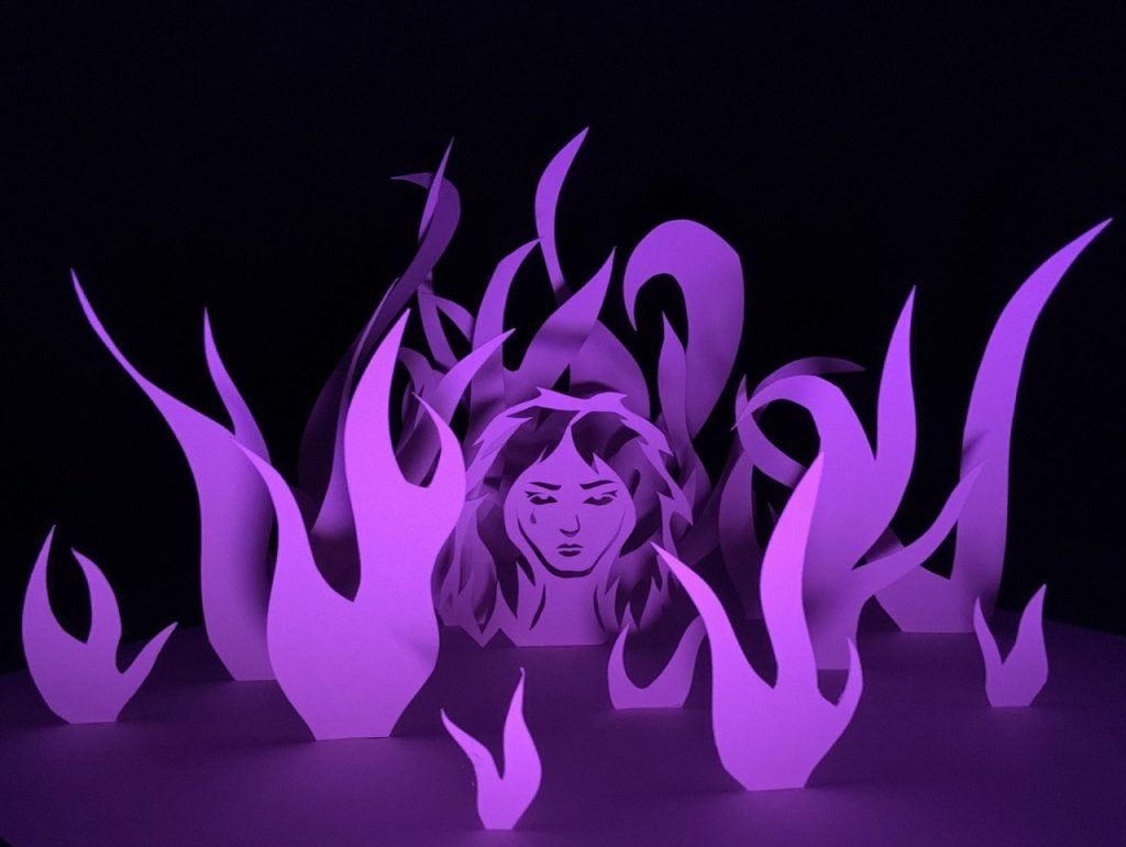 paper sculpture lit with purple lights